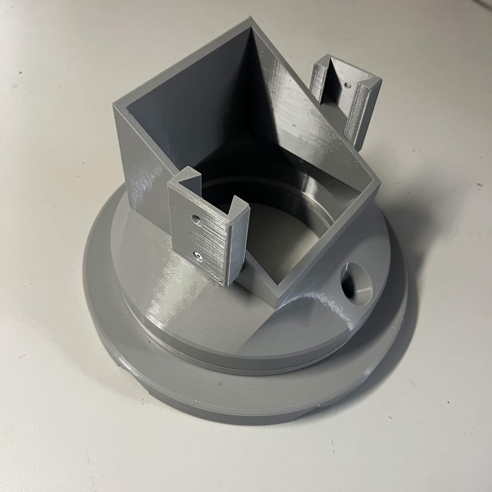 The finished bearing stack: the square chute mount standing on the round Lazy Susan and bottom static, with a layer connector bolted to the raised tab on each side face