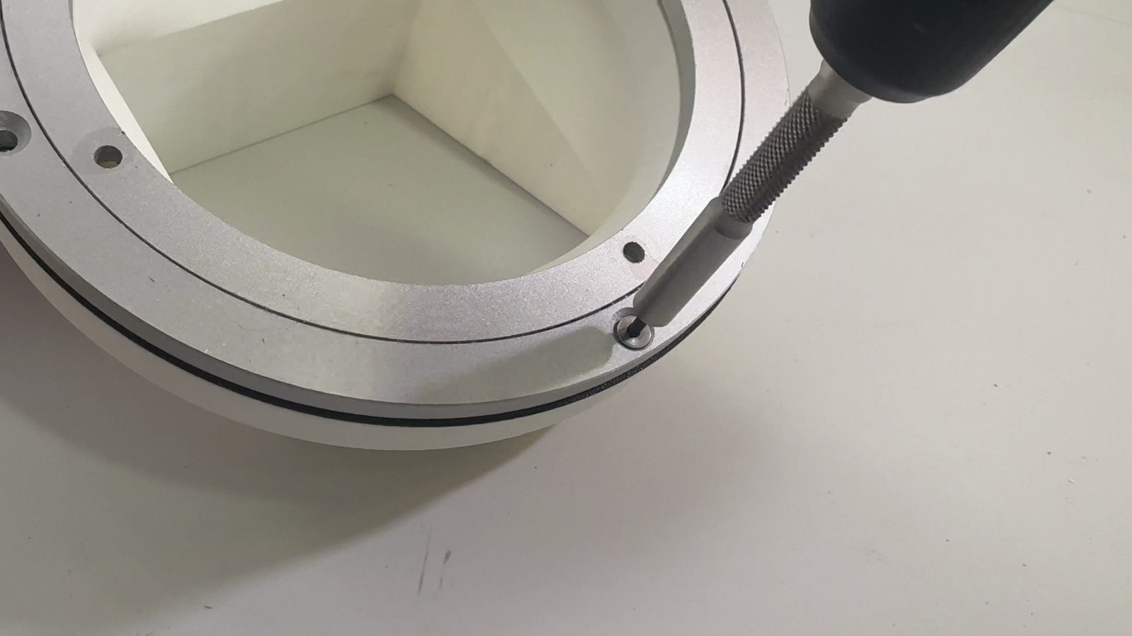 Driving a countersunk screw through the Lazy Susan into the chute mount