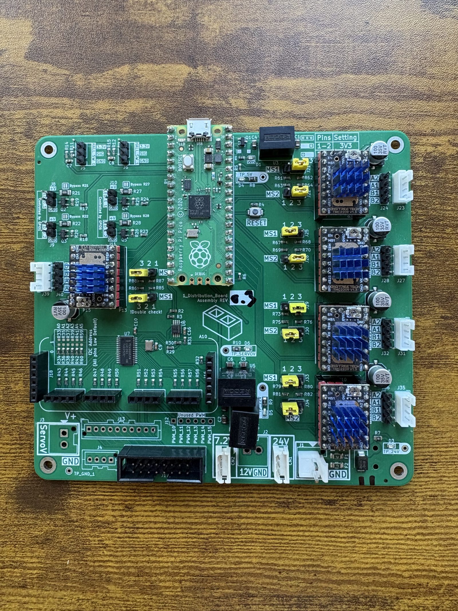 Top-down view of the fully populated control board, with five TMC2209 drivers, the Raspberry Pi Pico, and ten yellow jumpers fitted across the MS1 and MS2 headers