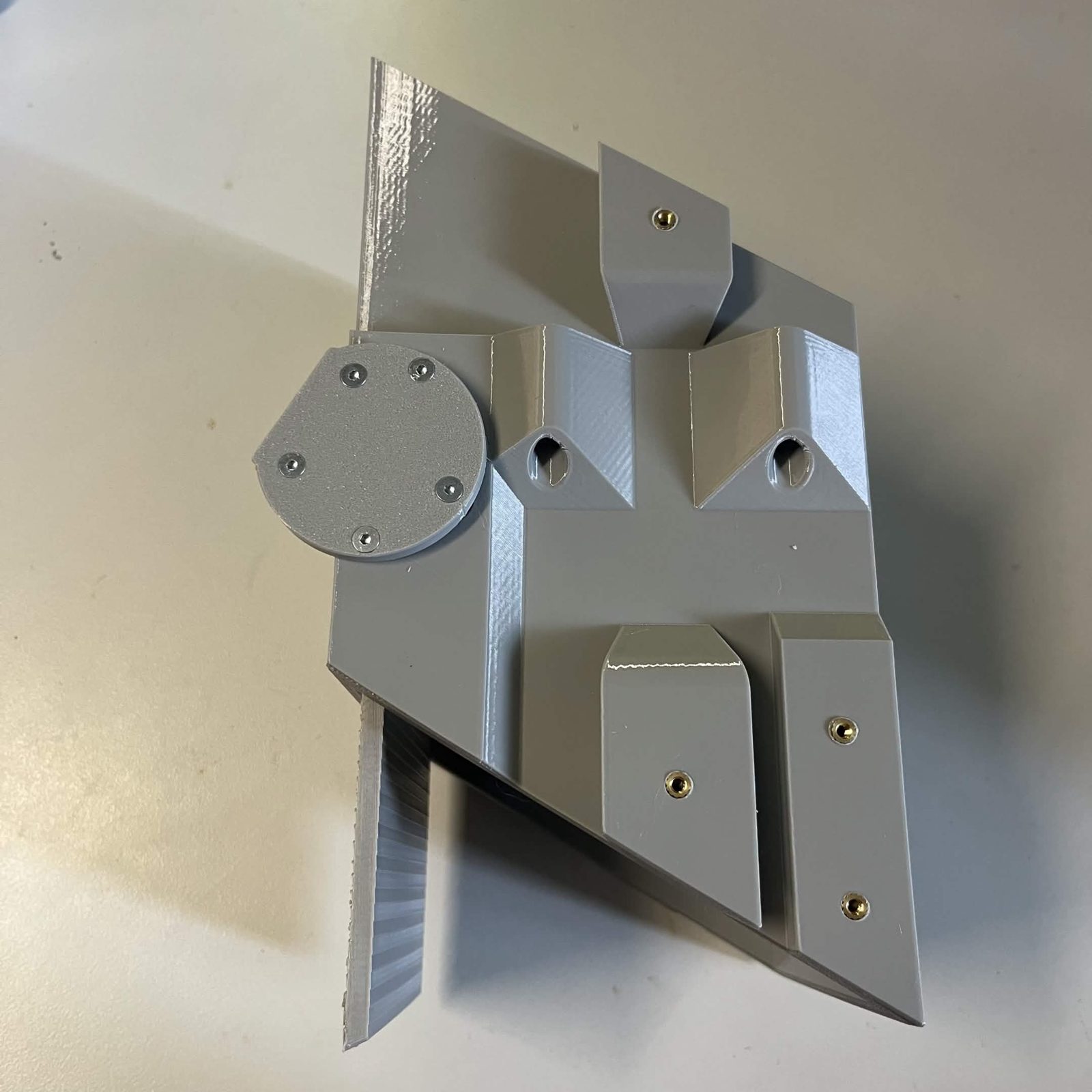The same assembly with the door fully open, the thin door plate hanging down clear of the core