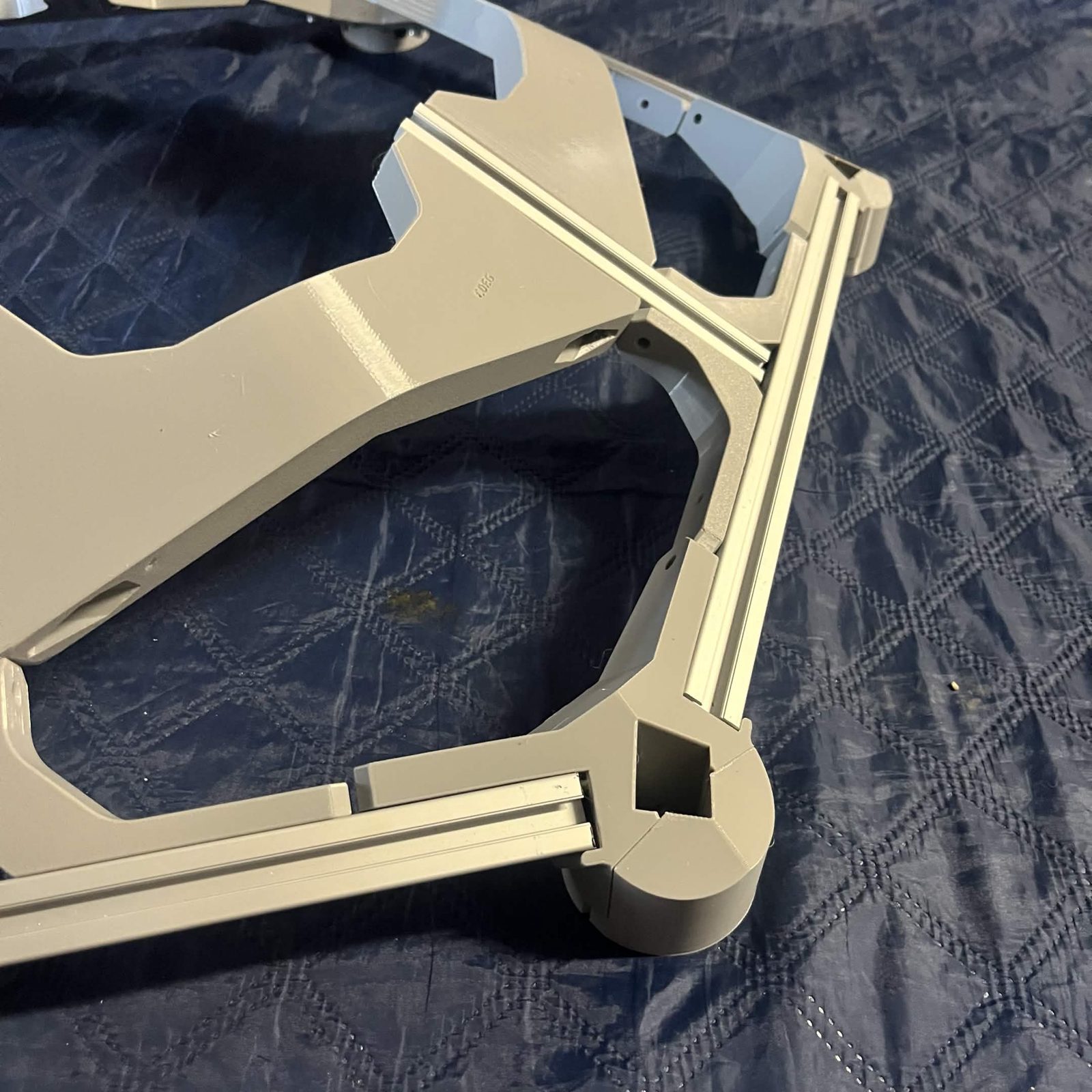 A hex frame corner with the cover pushed onto the External bracket side, the two closing into a round collar whose square socket is empty, no vertical extrusion standing in it