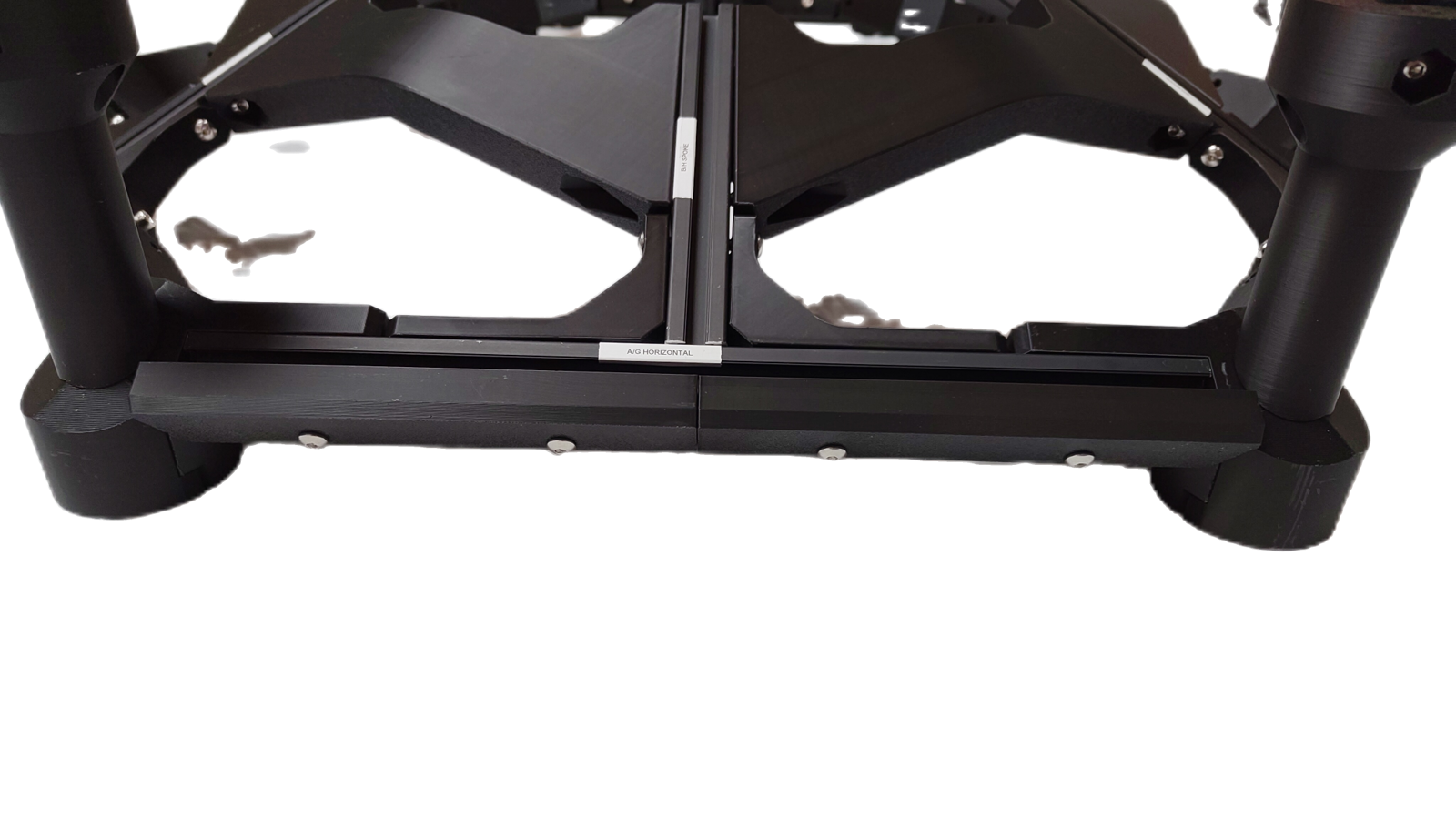 Bin retainers fastened to the outer faces of the hexagon frame, a pair either side of the joint between two A extrusions