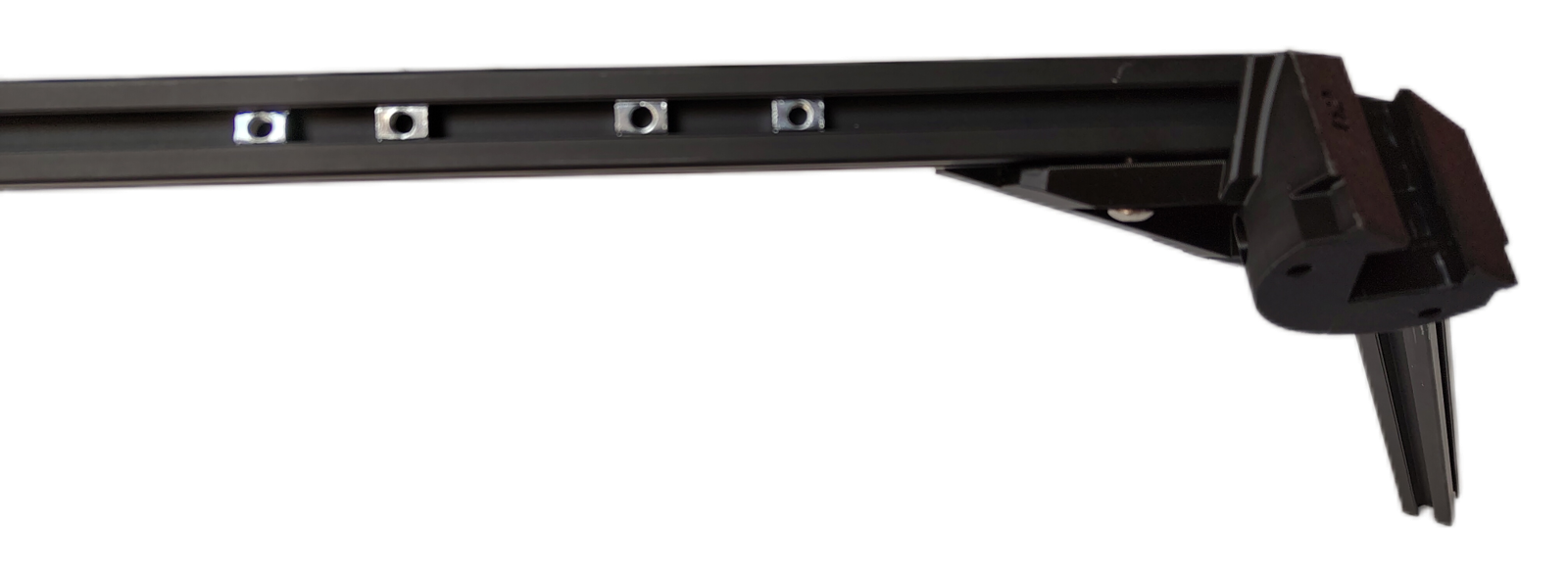 Side view along a 2020 aluminum extrusion with four roll-in T-nuts seated in its slot, evenly spaced, each showing its threaded hole, with an External bracket at the far end of the extrusion