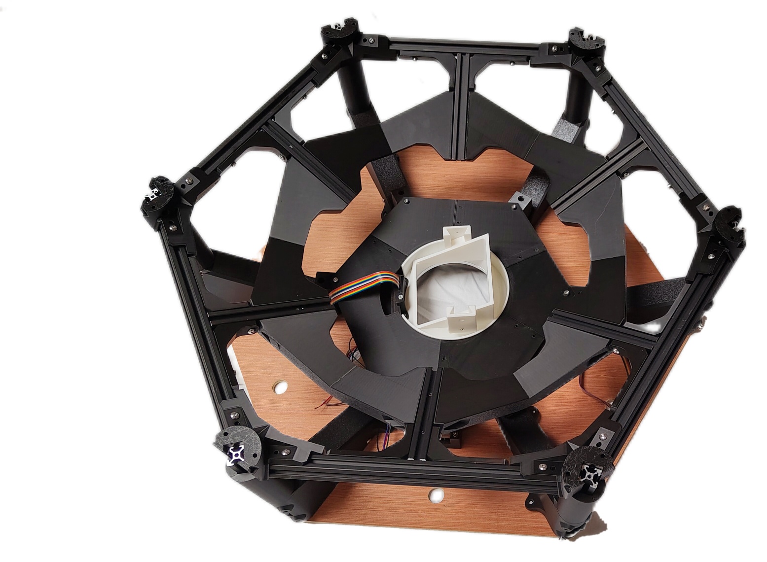 The completed top interface resting on its top plate: the hex frame ring uppermost, the six interface brackets and their extrusion inside it, and the white chute mount at the centre