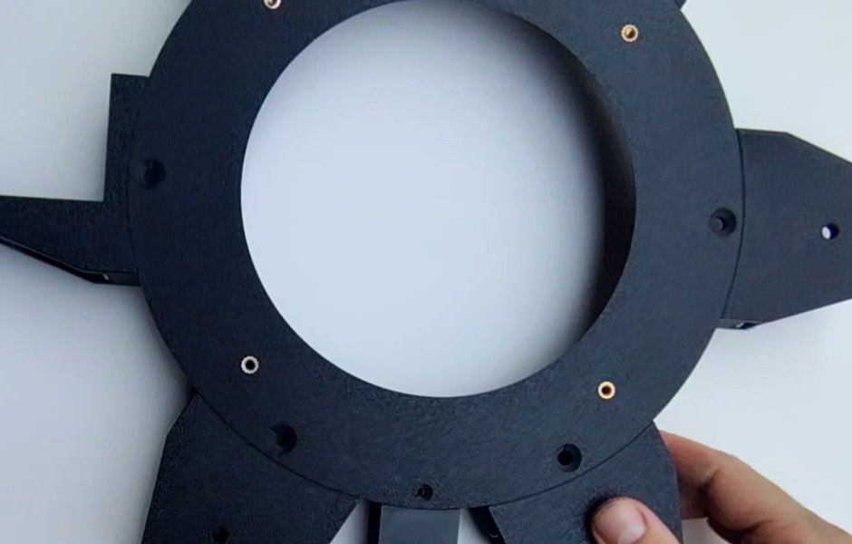 The Interface upper fixed section ring, underside with the NEMA 23 bracket attached, showing four brass M4 heat inserts around its face