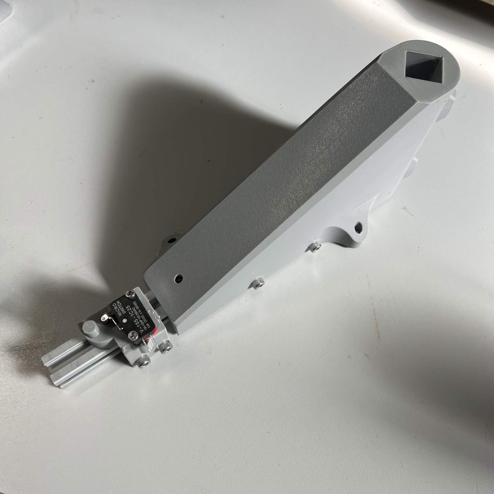The limit switch housing bolted to the extrusion of a prepared Interface bracket, seen along the whole length of the bracket