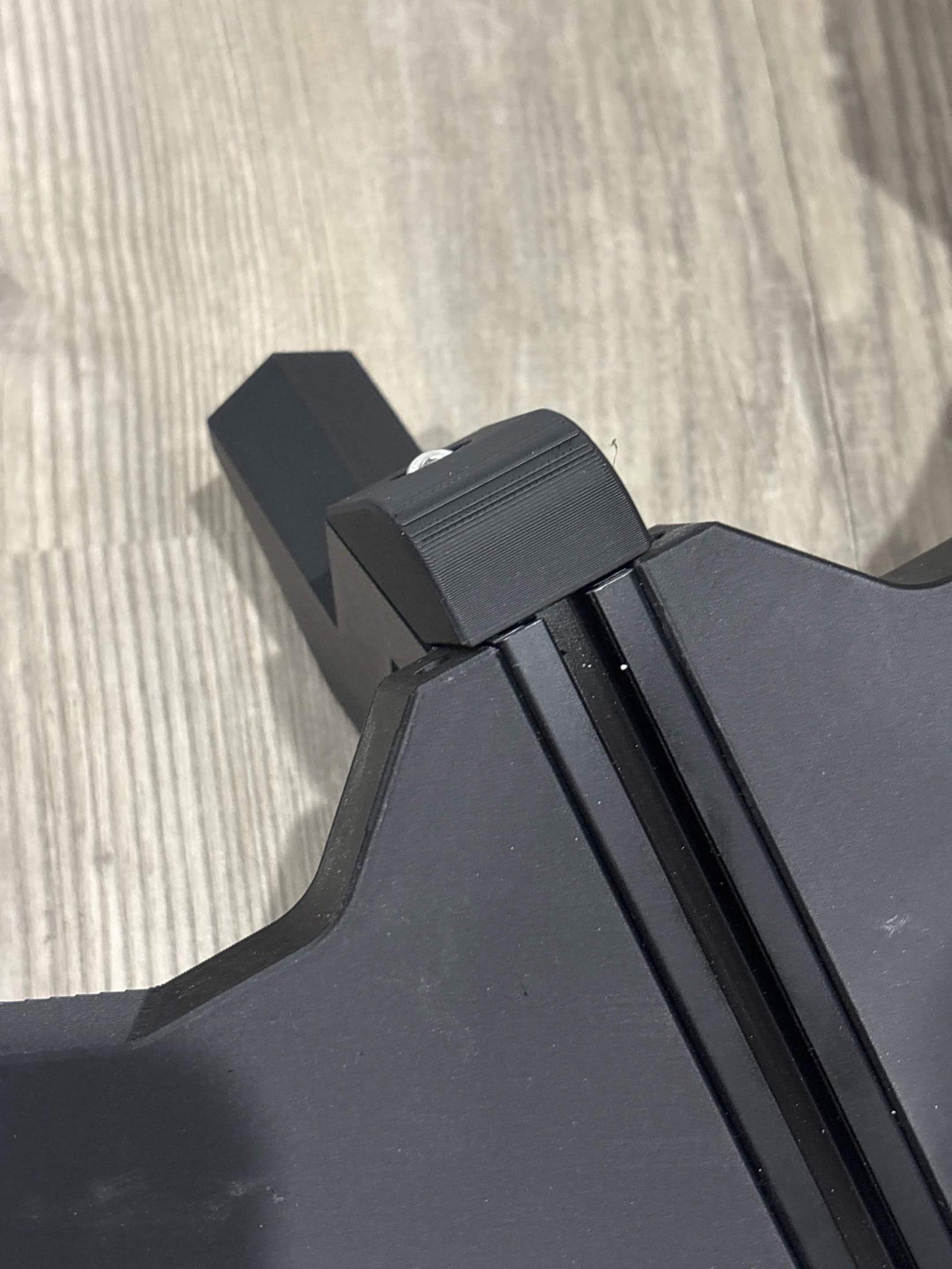 The mount and its hold in place seated down onto the spoke's extrusion, seen from the outside of the frame