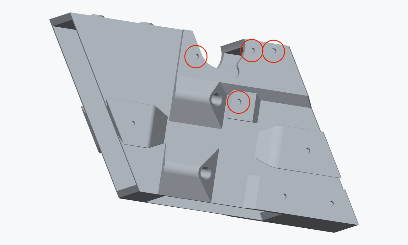 Render of the servo side of the chute core with four heat inserts circled in red