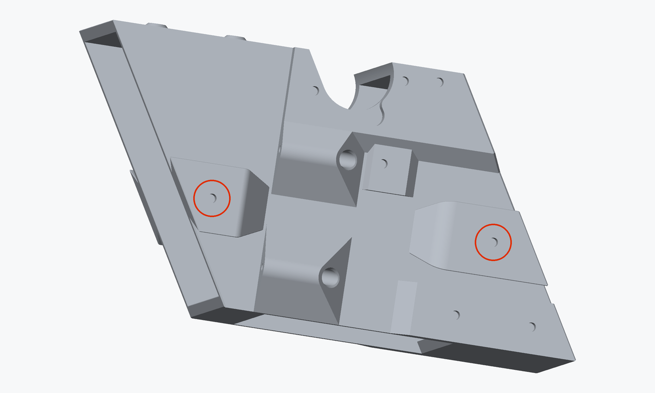 Render of one long side of the chute core with the two heat inserts a layer connector screws into circled in red