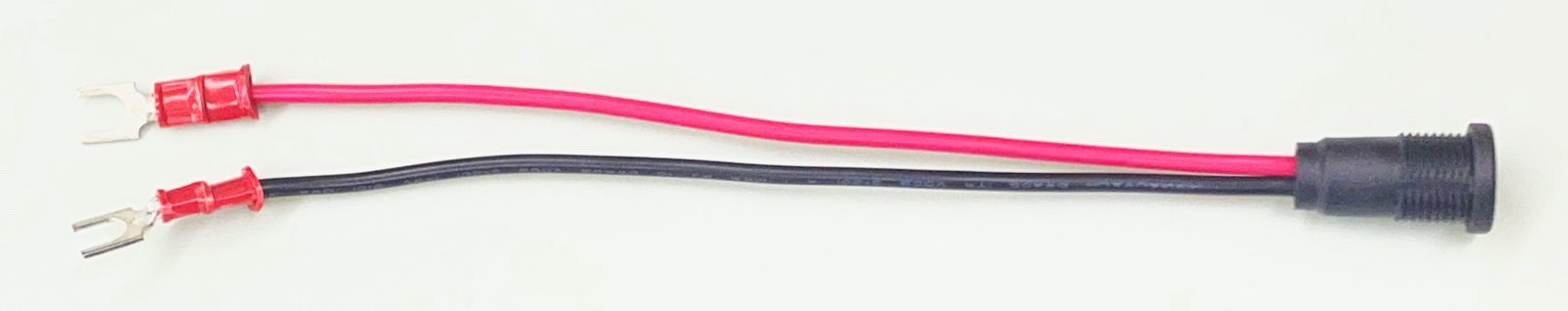 An assembled PSU output pigtail: a panel-mount barrel jack with red and black 18 AWG (0.82 mm²) leads, each ending in an insulated fork terminal