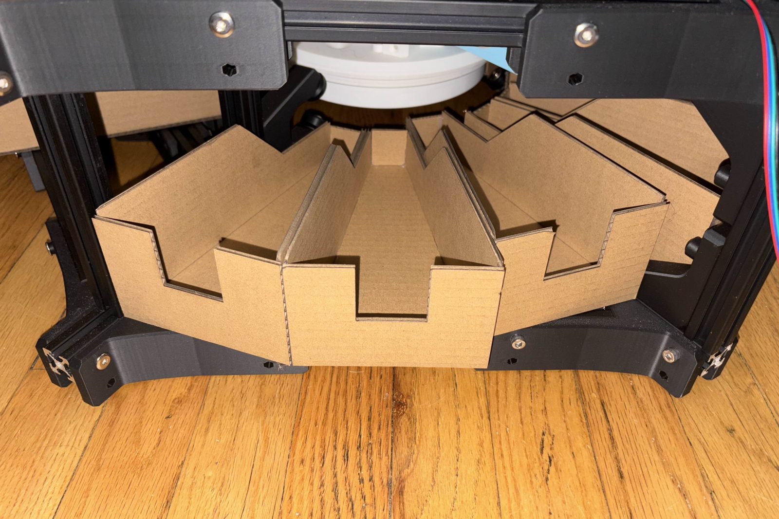 A layer seen from floor level, filled with folded cardboard bins radiating out from the chute in the middle