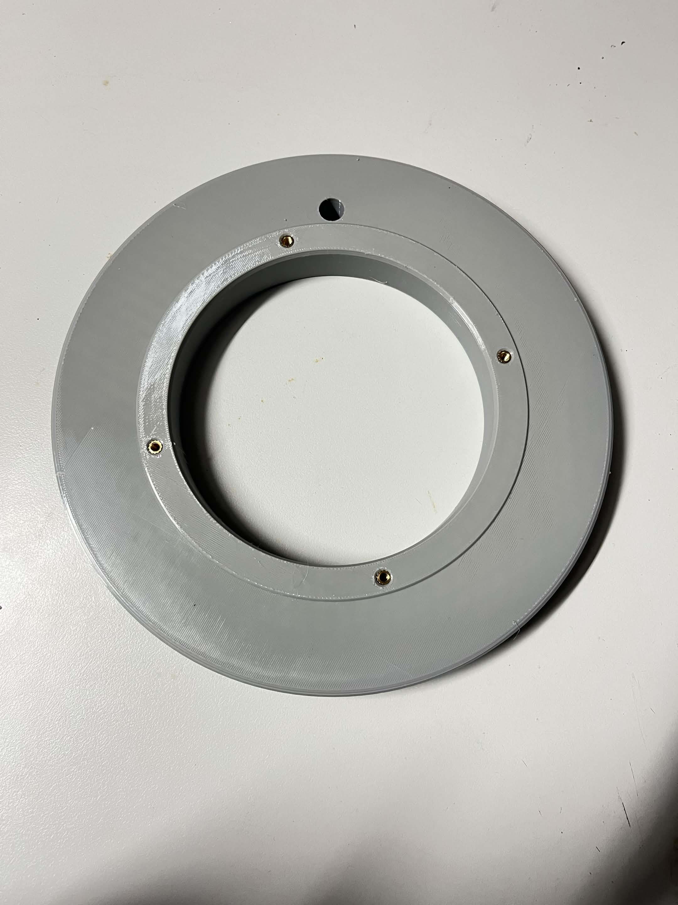 The flat Lazy Susan bottom static ring from above, with all four M4 heat inserts and a hole between two of them