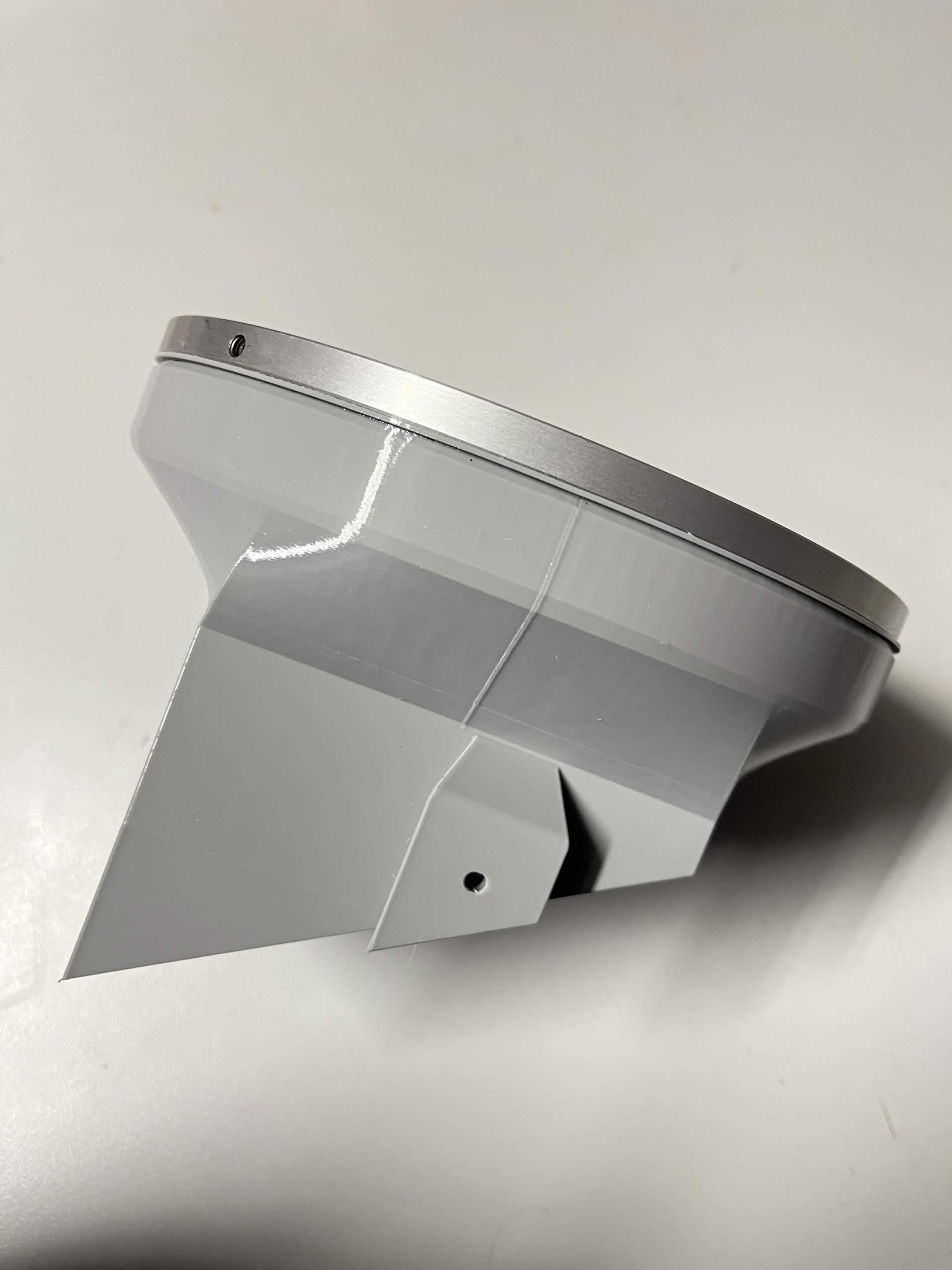 Side view of the bolted assembly with the thin white Lazy Susan washer visible sandwiched between the bearing and the chute mount