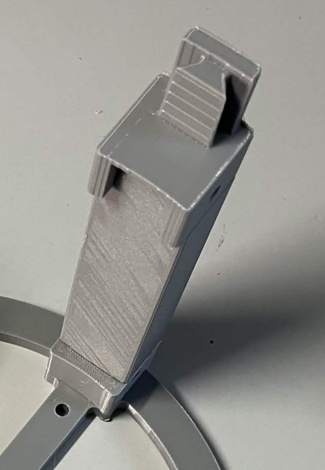 Close-up of one leg: it stands in the layout guide's square socket at the bottom, and the dovetail adapter caps its top, with a ribbed dovetail rail across the adapter's upper face