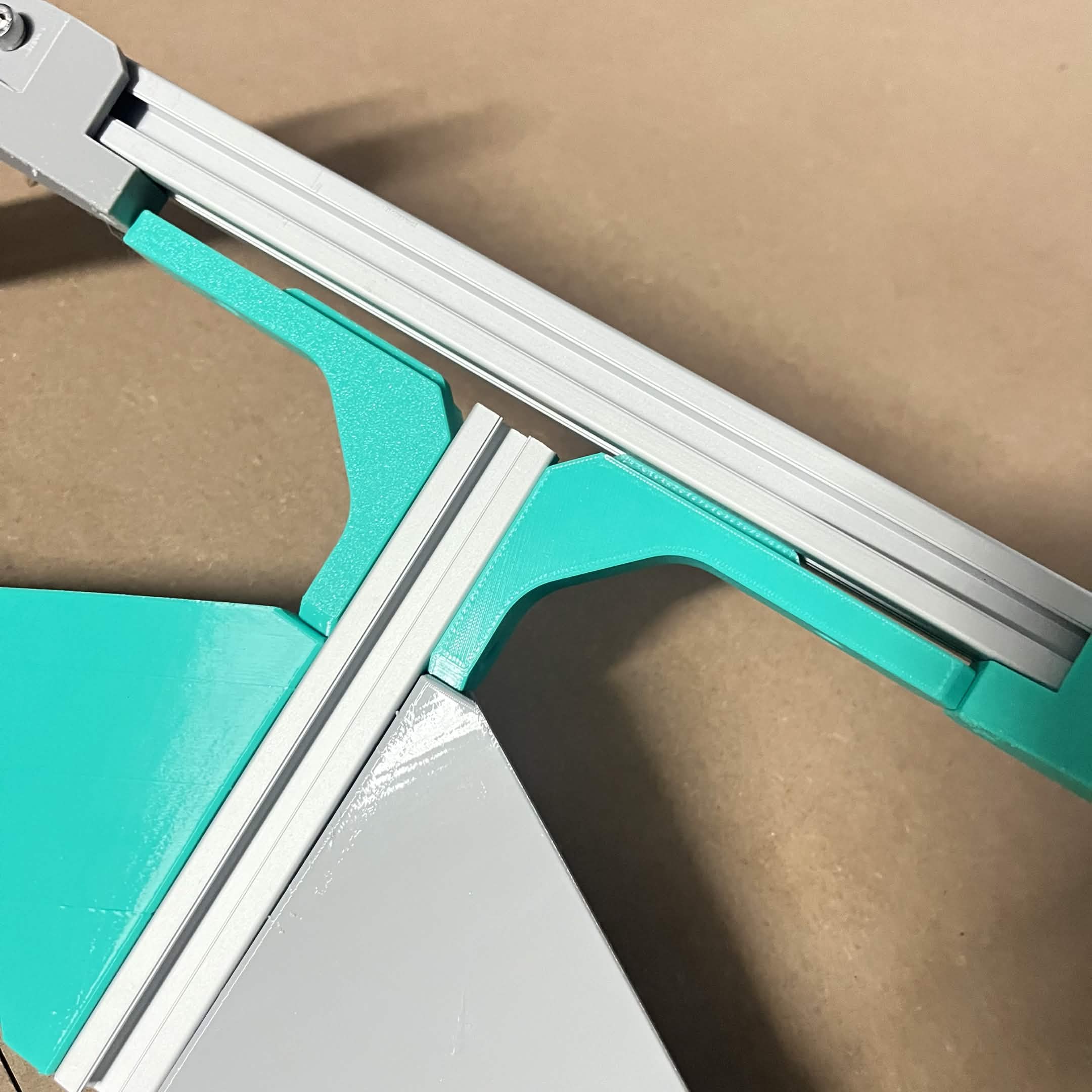 Close-up of a Frame 90 degree bracket's long leg slotted into the T-slot channel of the A extrusion