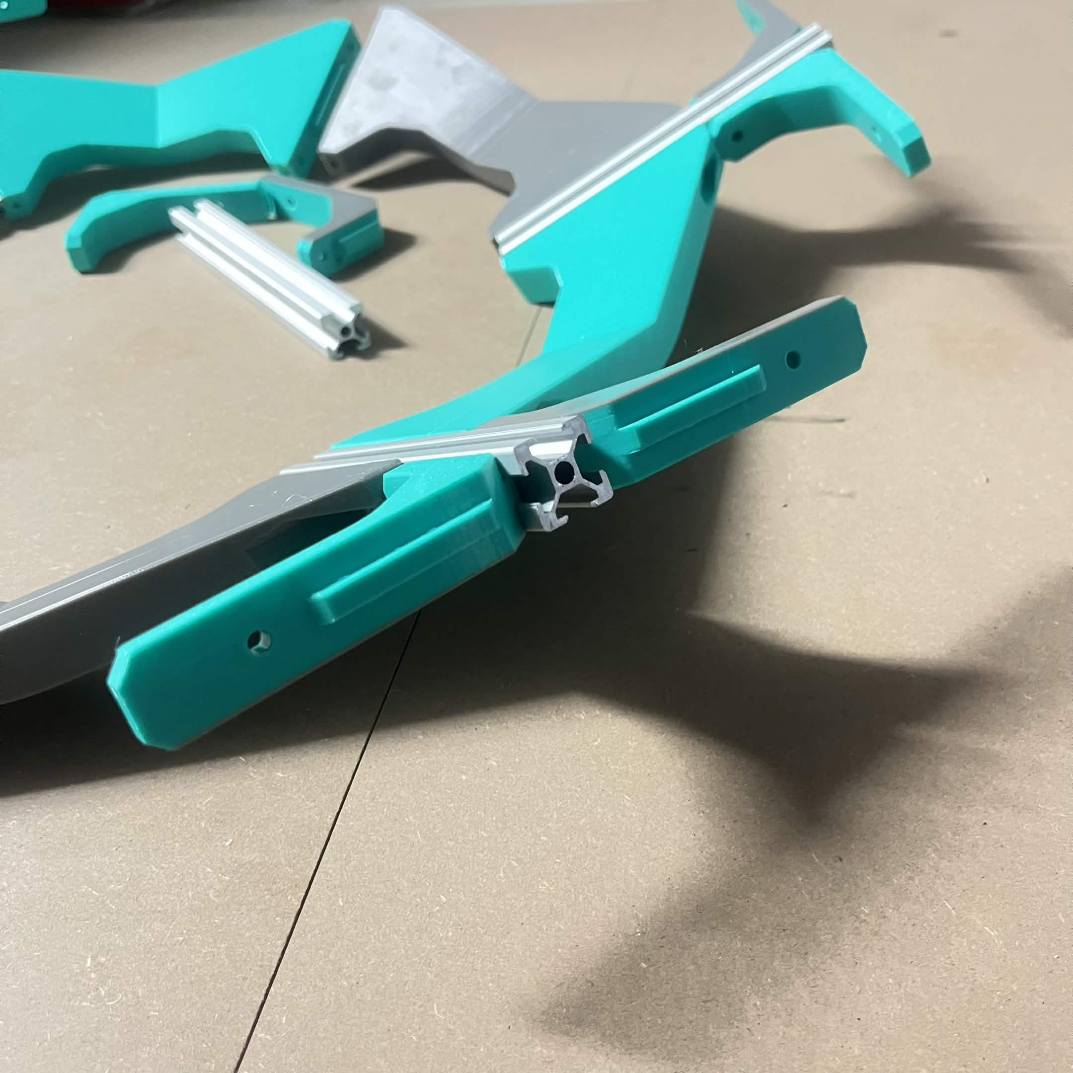 Close-up of a Frame 90 degree bracket's short leg seated on the spoke extrusion and its long leg reaching out toward where the outer ring will sit