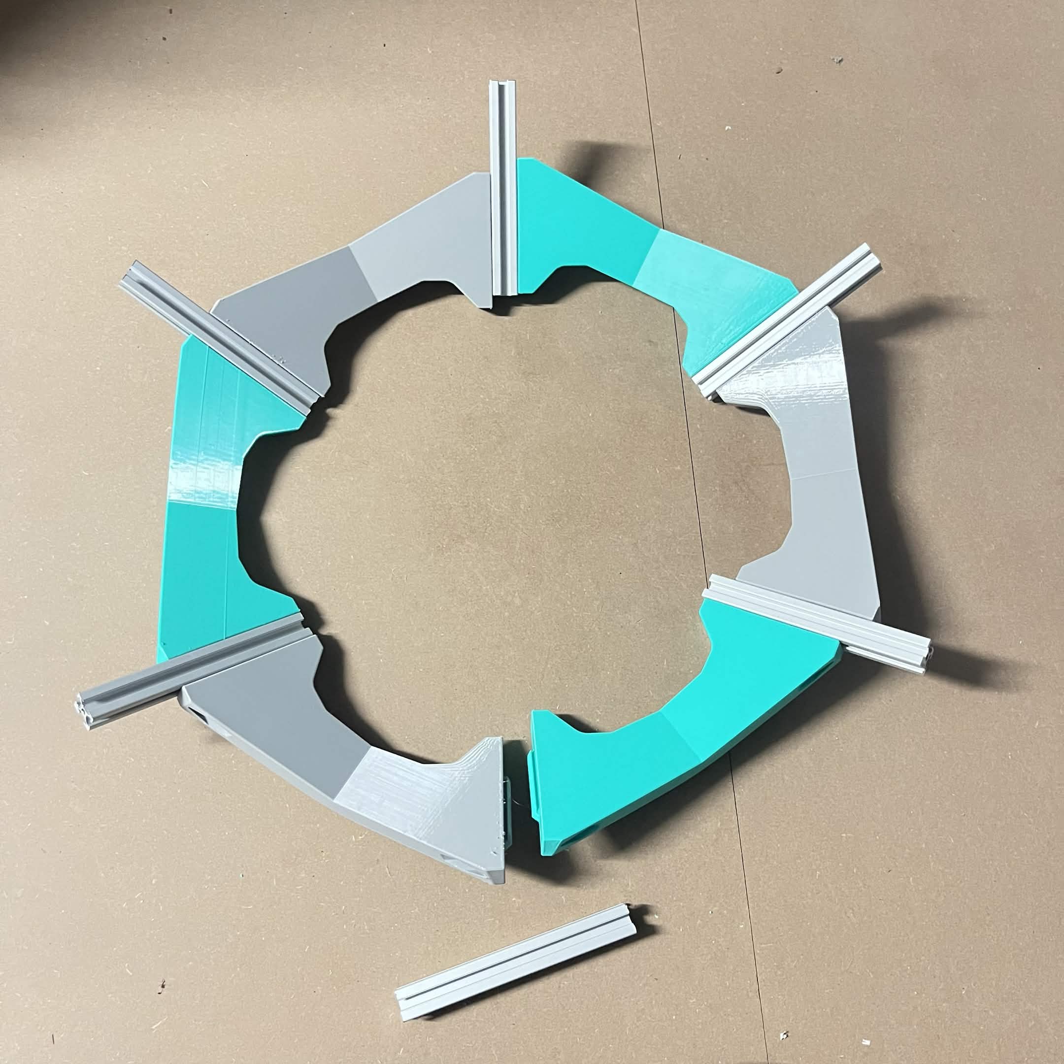 Five spoke-and-crossbeam joints forming most of a hexagon, one B spoke and its extrusion still sitting loose at the open side